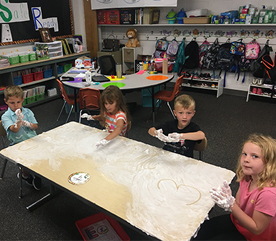 students playing with shaving cream at their desks
